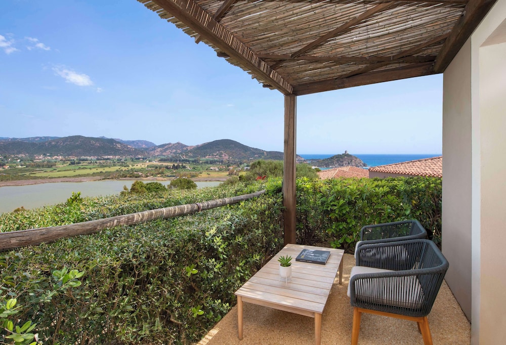Baia di Chia Resort Sardinia, Curio Collection by Hilton — Hotel rooms in Domus de Maria, Sardinia
