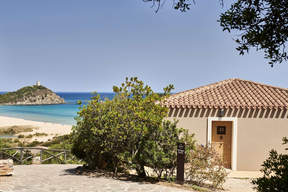 Baia di Chia Resort Sardinia, Curio Collection by Hilton — Hotel building in Domus de Maria, Sardinia
