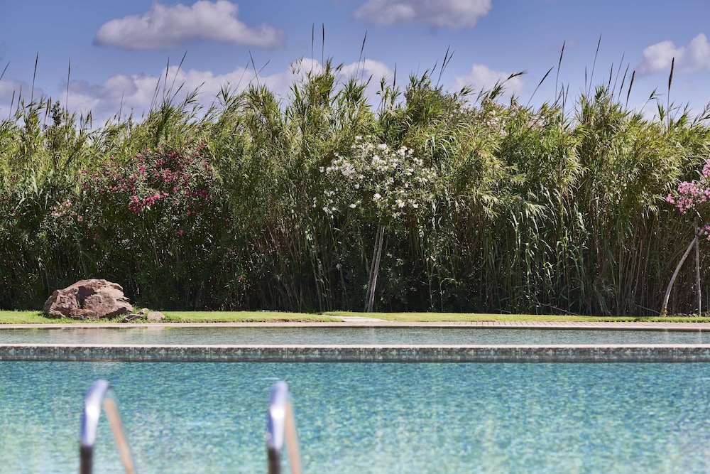 Baia di Chia Resort Sardinia, Curio Collection by Hilton — Swimming pool in Domus de Maria, Sardinia