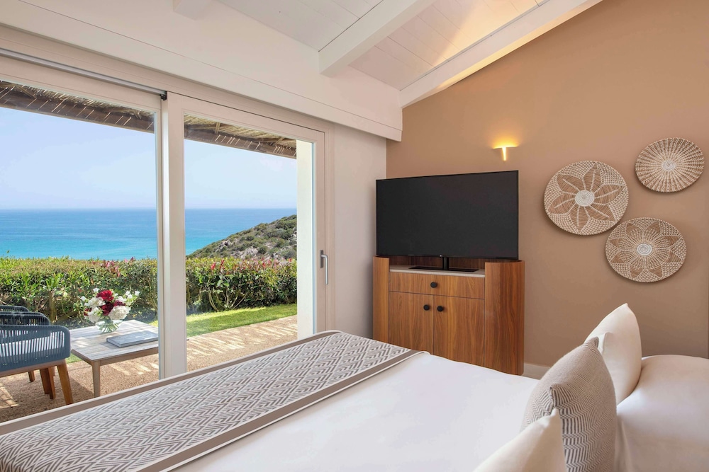 Baia di Chia Resort Sardinia, Curio Collection by Hilton — Hotel rooms in Domus de Maria, Sardinia